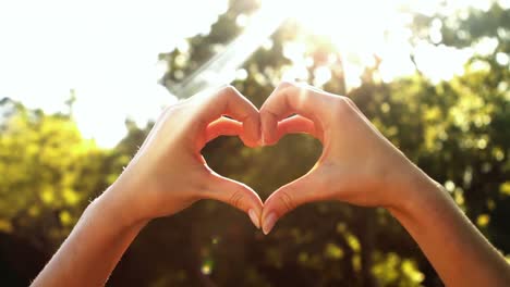 hands of woman forming a heart shape