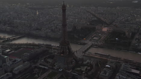 Backwards-fly-above-town-development.-Known-tourist-attractions-along-Seine-river.-Eiffel-Tower-and-Jardins-du-Trocadero-at-dusk.-Paris,-France