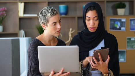 Female-executives-discussing-on-laptop-and-digital-tablet-4k