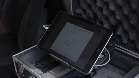 an android tablet connected to a remote controller with usb cable connector - closeup shot