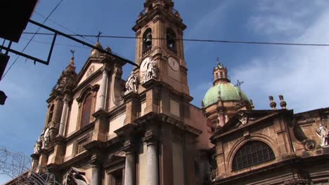 A-low-angle-of-a-religious-building-below-a-cloudy-blue-sky-Palermo-Italy--