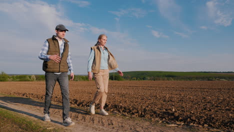 couple walking through a field