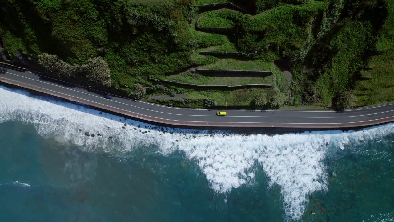 Coastal Road with Waves and Surrounding Mountains