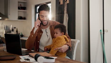 father working from home with baby