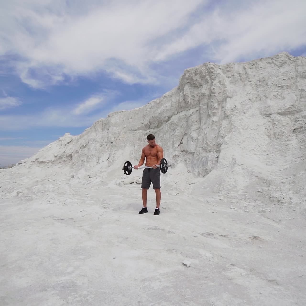 Man with weight training on nature