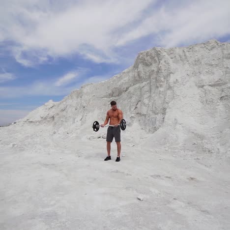 man with weight training on nature
