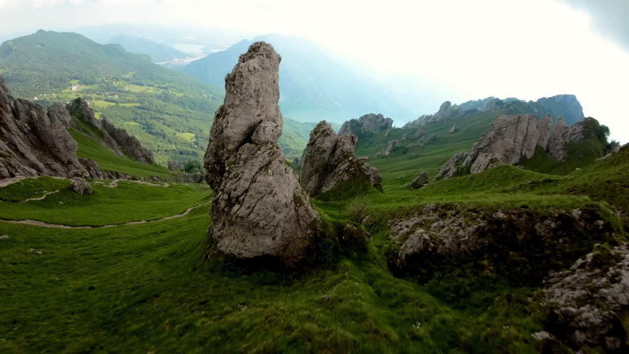 Drone flying around Rosalba refuge and descending over slope of mountain, summer season, Grigna in Italian Alps, Italy, FPV