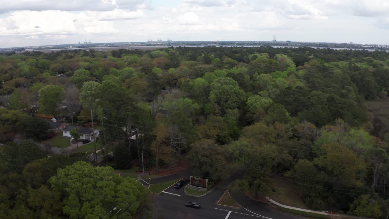 Aerial wide reverse pullback shot of the Old Charles Town Landing along the banks of the Ashley River at Albermarle Point, South Carolina