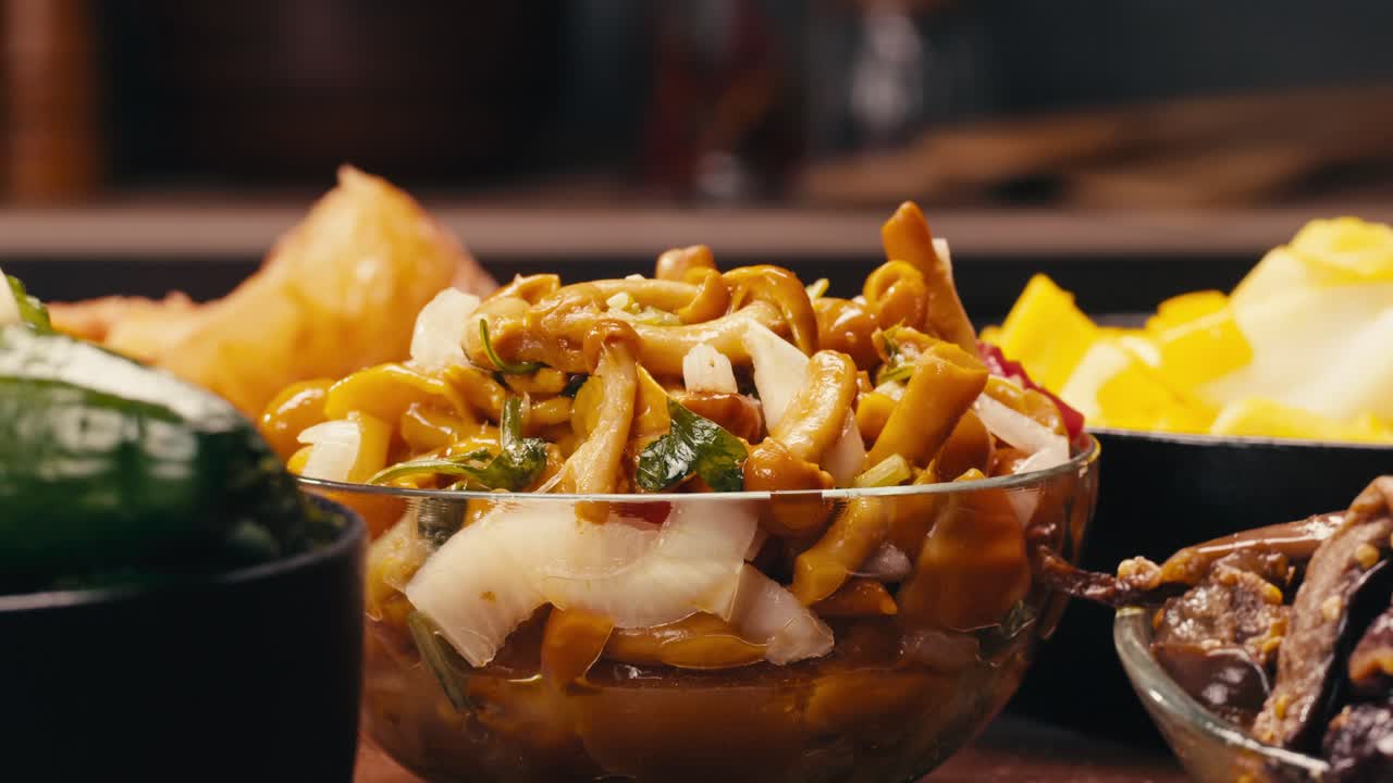 Close-up of fermented yellow honeydew mushrooms with onion in plate. Preservation of vegetables in glass jars. Fermentation preserved mushroom with spices.