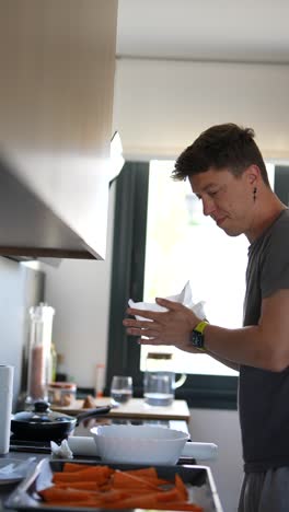 man preparing carrots in the kitchen