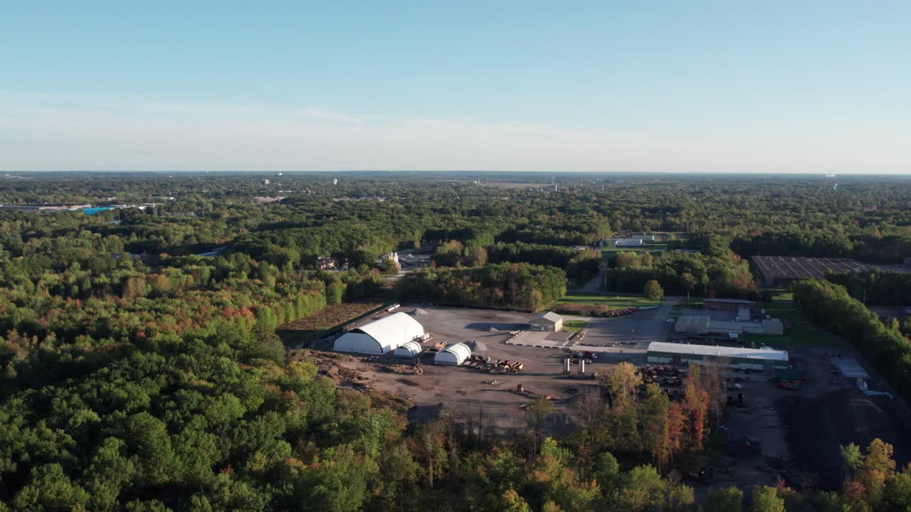 An aerial shot of beautiful autumn landscape with yellow trees and sun