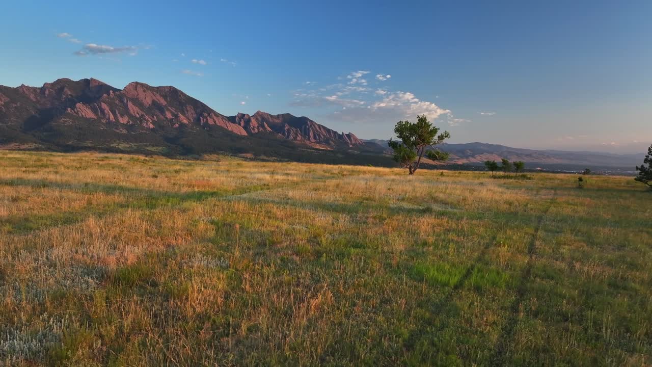 Greenbelt Plateau Flatirons Front Range Boulder Creek neighborhood Chautauqua Park morning sunrise aerial drone Colorado spring summer first light red slanted Rocky Mountains Pikes Peak circle left
