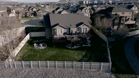 home in a suburb - backyard deck then aerial reveal of the neighborhood