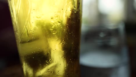 close-up of beer glass with bubbles rising