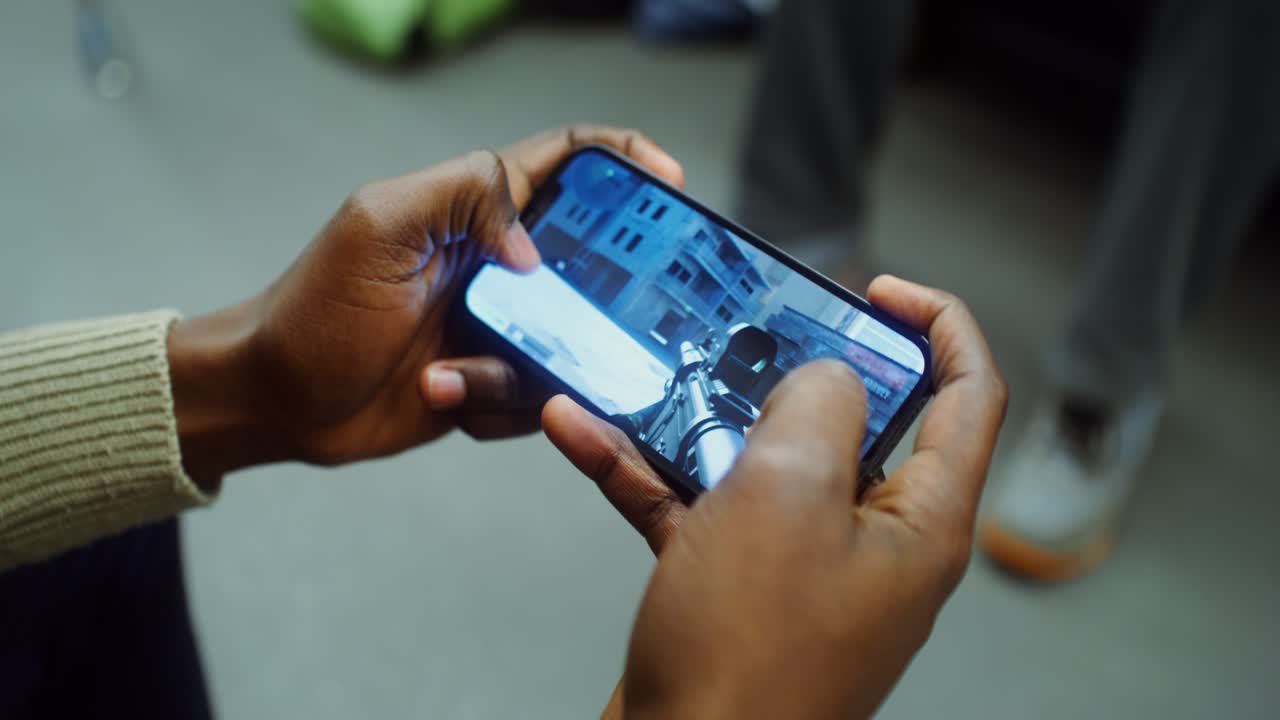 A person playing a mobile game on a cell phone