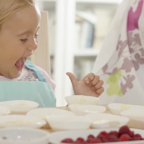 happy little girl with empty muffin holders