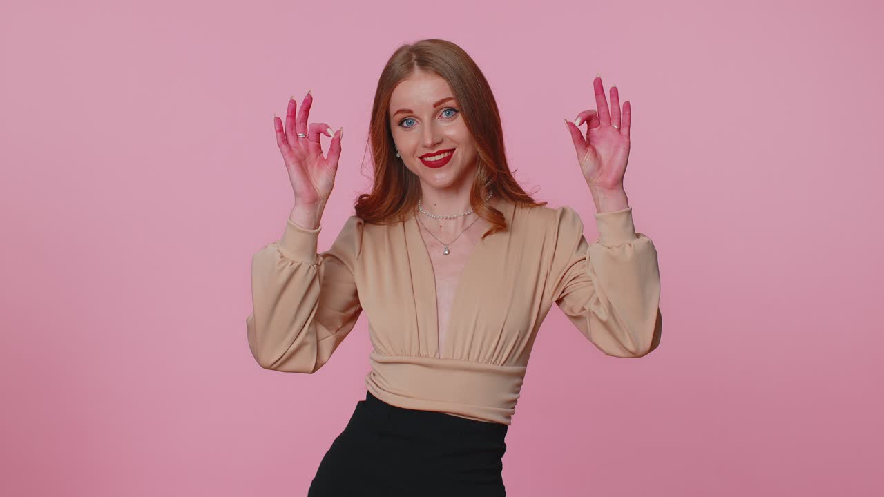Positive businesswoman girl showing ok gesture like sign positive something good on pink background
