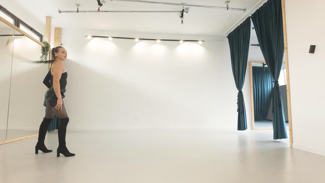 Low angle view of skilled girl doing acrobatic handstand in a studio