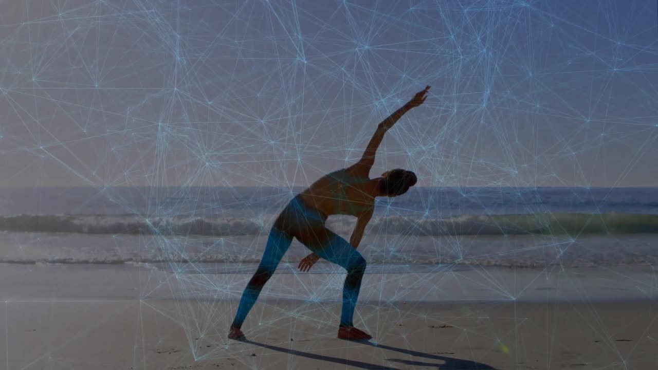Yoga practitioner planting right foot on wet sand initiating side triangle aligning against waves