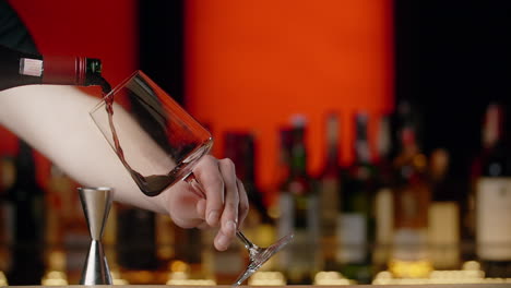 bartender pouring red wine