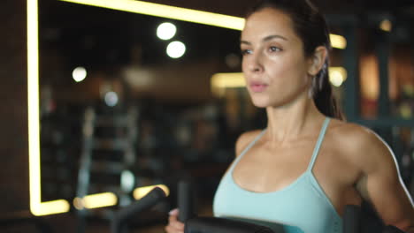 Sporty-girl-warming-up-at-gym