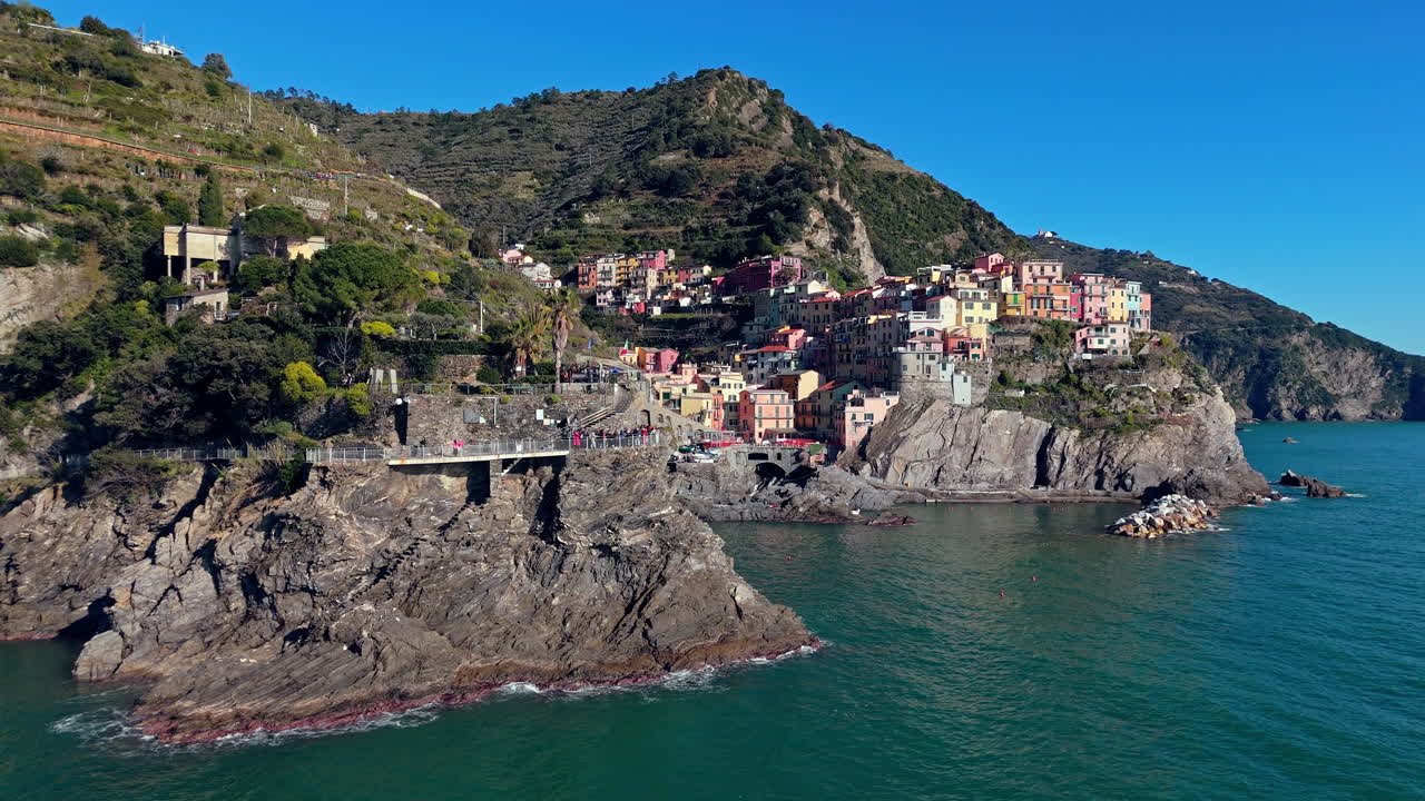 Colorful houses on the coast of Manarola, Cinque Terre, Italy, by the sea