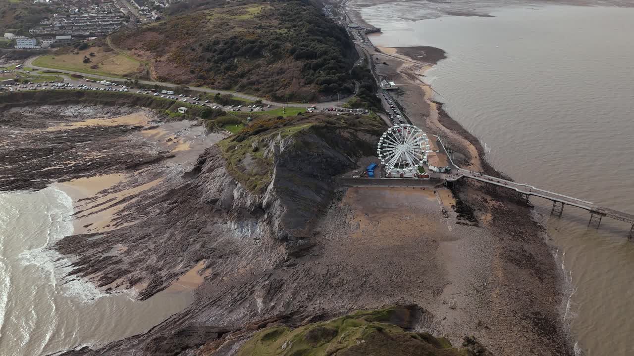 Dramatic view of The Big Wheel at Mumbles Pier Swansea in England. Aerial shot.