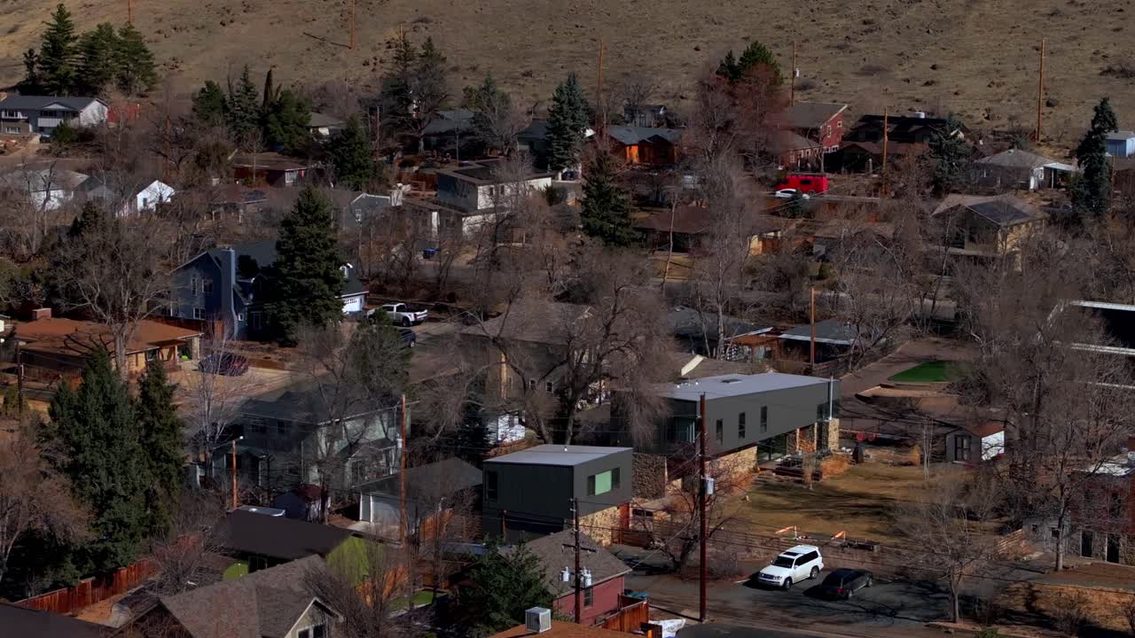 Historic Golden Colorado aerial drone neighborhood homes condominiums buildings Colorado School of Mines cars streets trees telephone lines North Table Mountain slow pan to the left motion