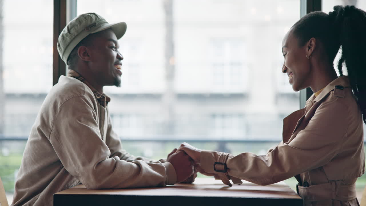 Couple, love and holding hands on table