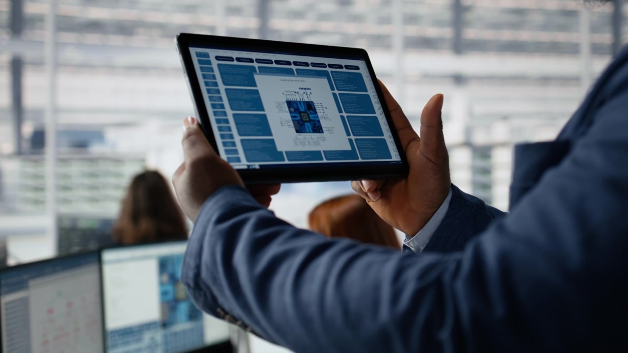 Professional Man Holding Digital Tablet Displaying Microchip Security Tools