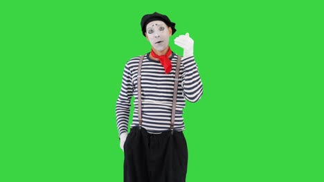 mime talking on imaginary phone on a green screen, chroma key