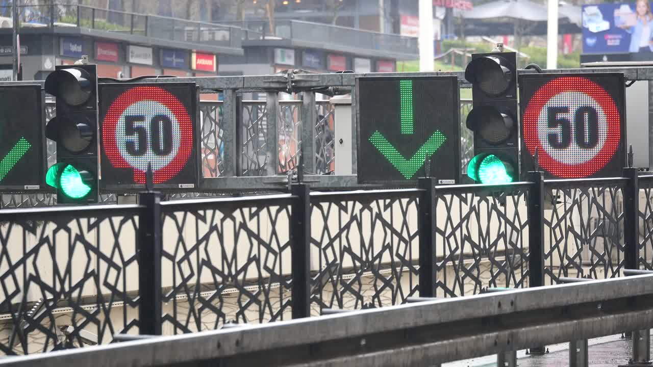 Traffic signs with speed limit 50 and down arrow in city street