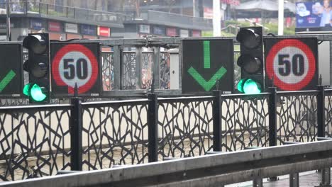 traffic signs with speed limit 50 and down arrow in city street