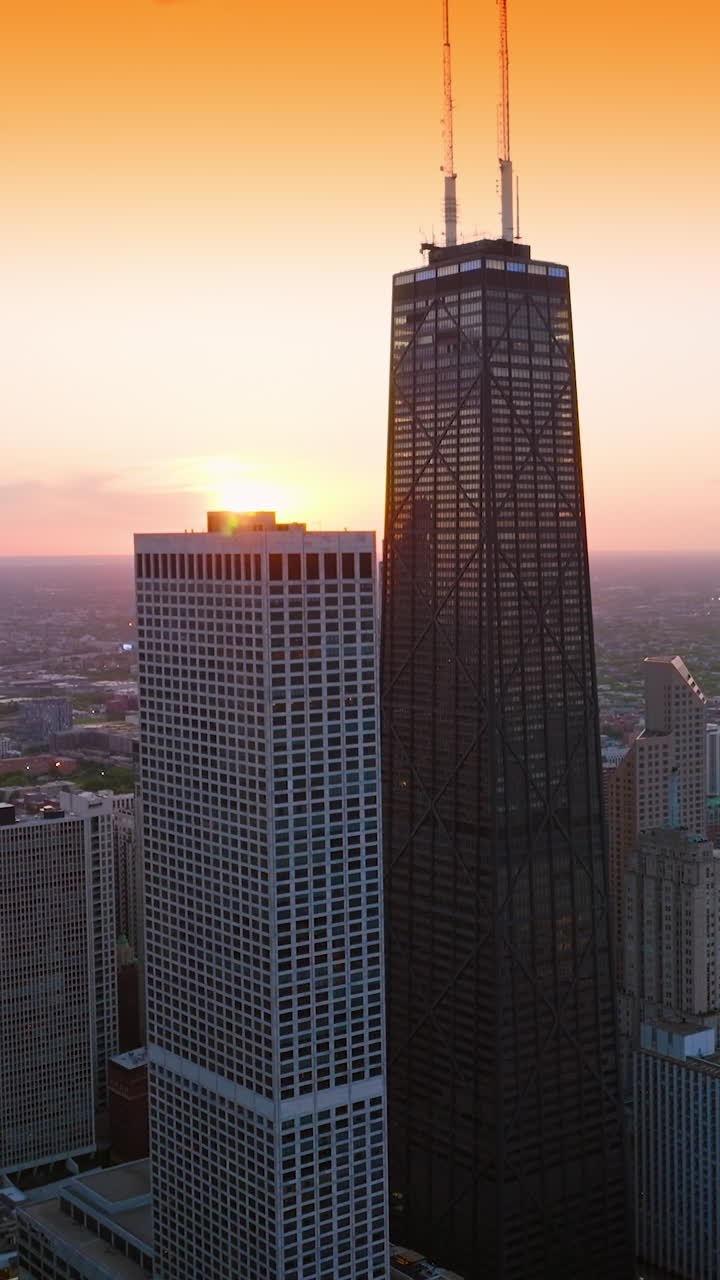 Delightful sight of amazing architecture at the waterfront of Lake Michigan. Stunning skyscrapers at Chicago downtown at the backdrop of yellow sky. Aerial view. Vertical video