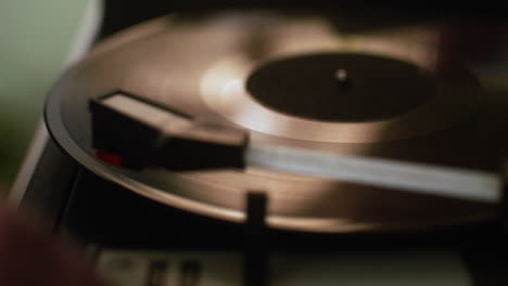 man putting a vinyl disc on