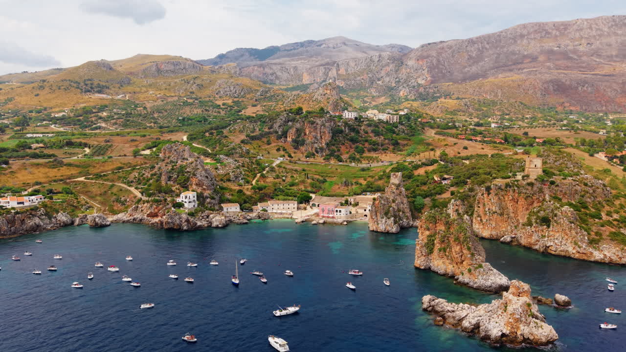 Aerial dolly out revealing Scopello rocky coast at day time