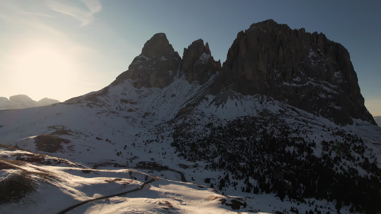 Aerial View of Sella Pass on Sunny Spring Day, Winding Road in Snow Capped Hills of Italian Dolomites