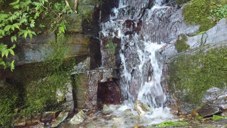 Small-cascading-waterfall-flowing-downhill-in-Longji-Rice-Terraces,-China