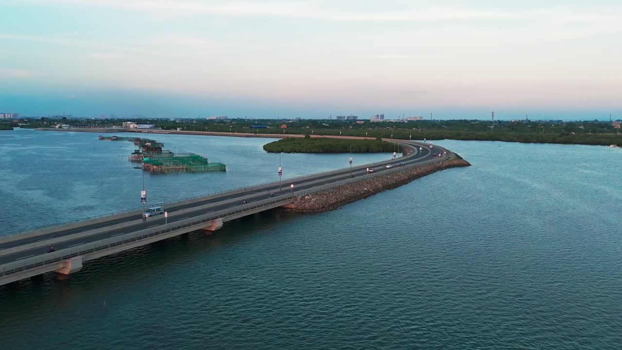 4K cinematic aerial drone video of a modern coastal highway bridge over the blue ocean at sunset in Cebu, Philippines. Ideal for tourism, transportation, infrastructure, sustainability, and travel