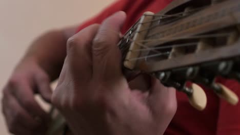 close up of a musician picking on a classical guitar