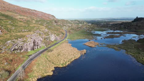 Drone-view-of-a-road-near-a-lake-in-the-Gap-of-Dunloe,-Ireland