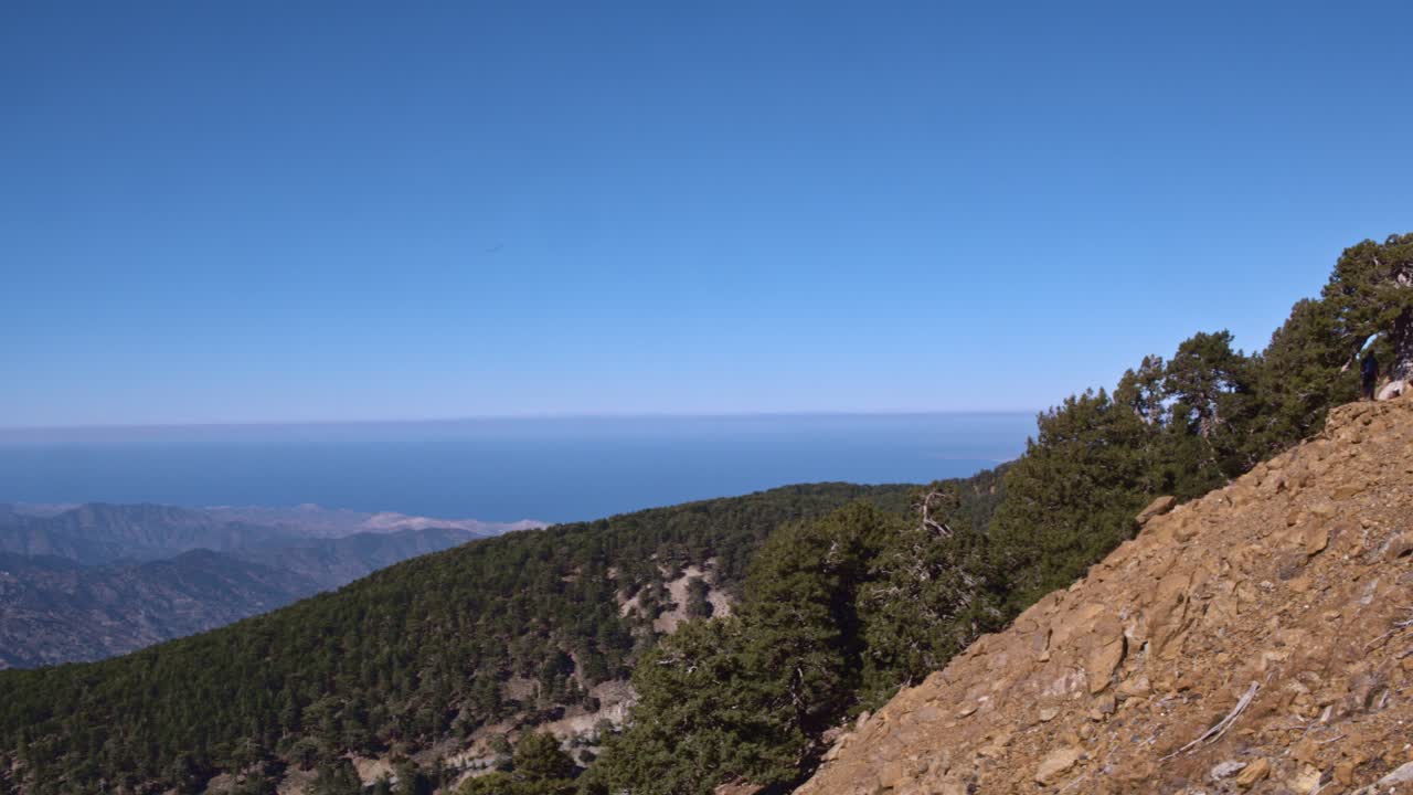walkers hiking along treacherous steep mountain trail