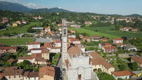 Establisher-aerial-of-Pagnano-church-tower-square-and-town,-circle-pan,-day