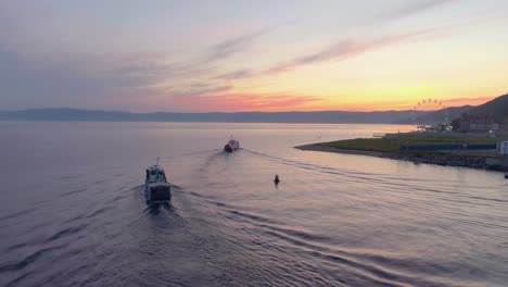 sunrise over lake with boats