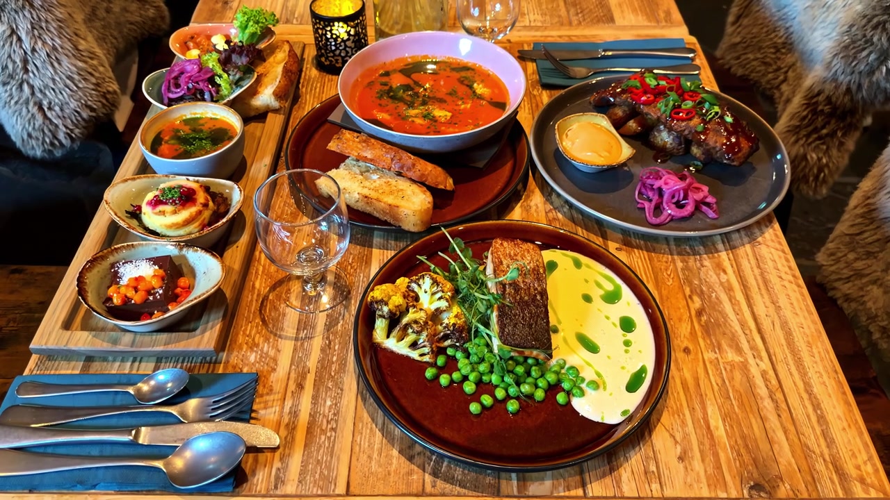 Assorted traditional Norway dishes served on rustic wooden table indoors.