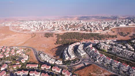 aerial footage of israel and palestine town divided by fence