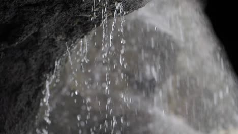 water dripping from a rock into a waterfall