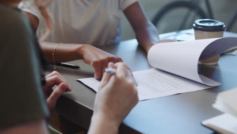 people signing documents at a meeting