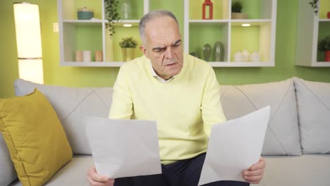 old man reading document, report, bank papers, contract.