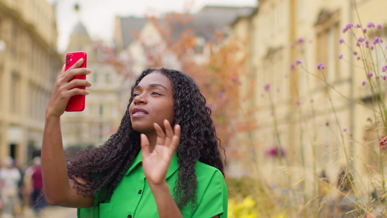 Female Tourist On Vacation In Oxford UK Exploring City Walking Along Broad Street Taking Photo With Mobile Phone 3